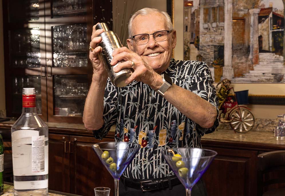 Jerry shaking an alcoholic beverage in a home bar